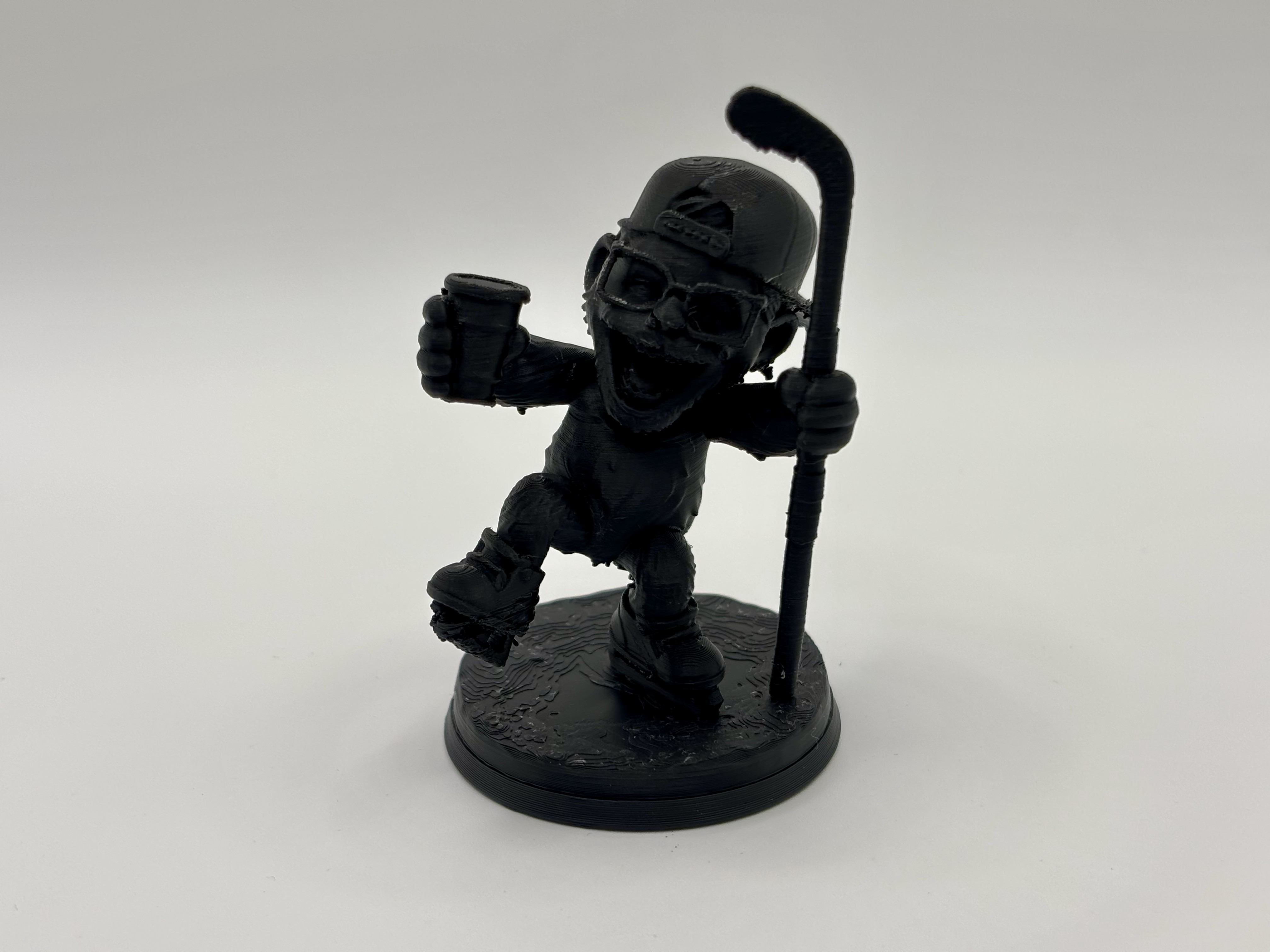 3D printed drunk hockey player miniature with stick and drink by Onyx 3D 				Printing