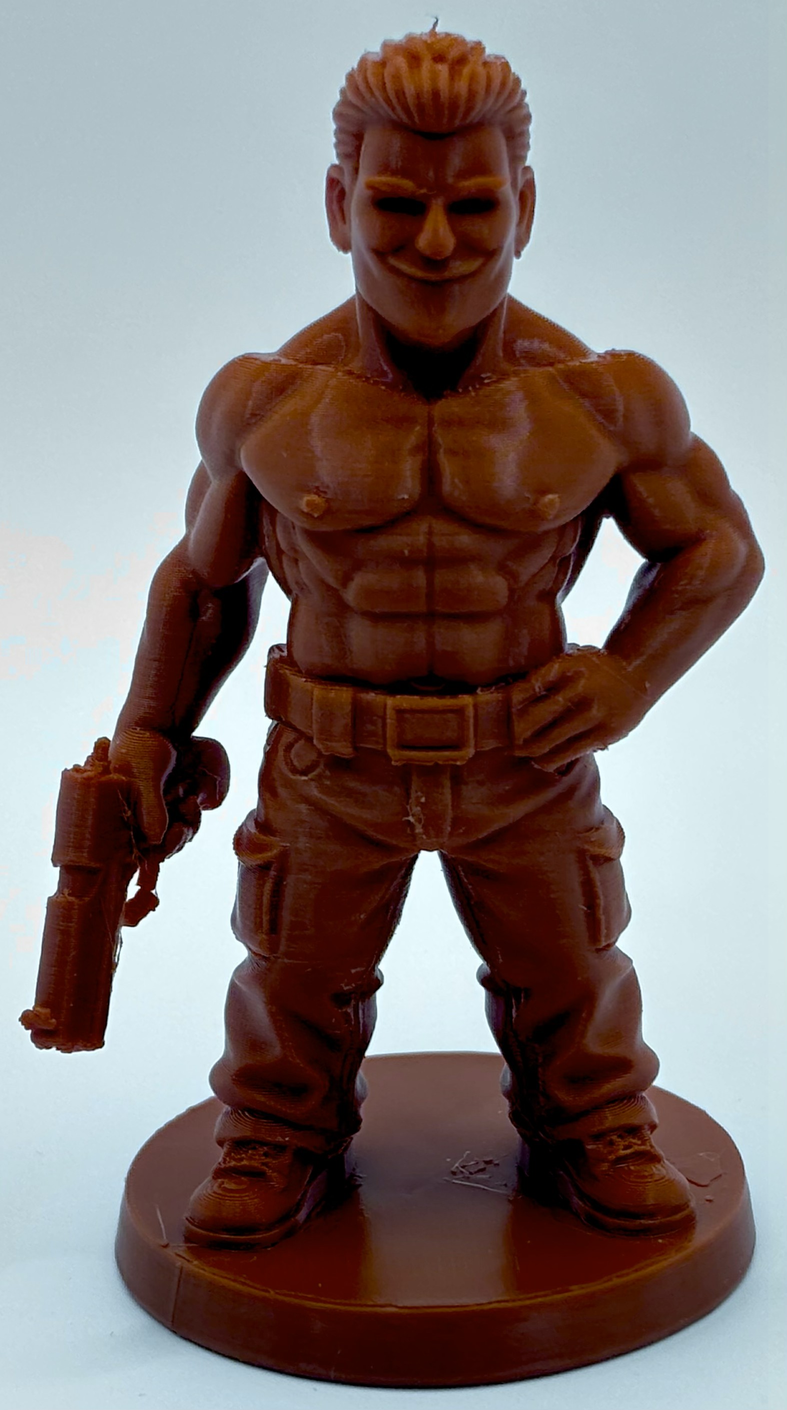 3D printed muscular male figurine holding a handgun by Onyx 3D Printing