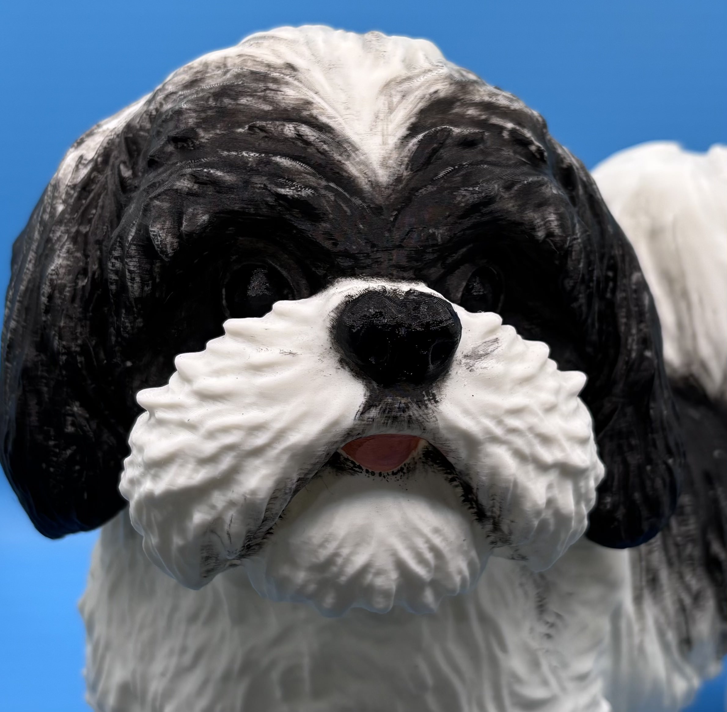 Close-up of a custom 3D printed dog figurine face showing detailed eyes, nose, and fur texture
