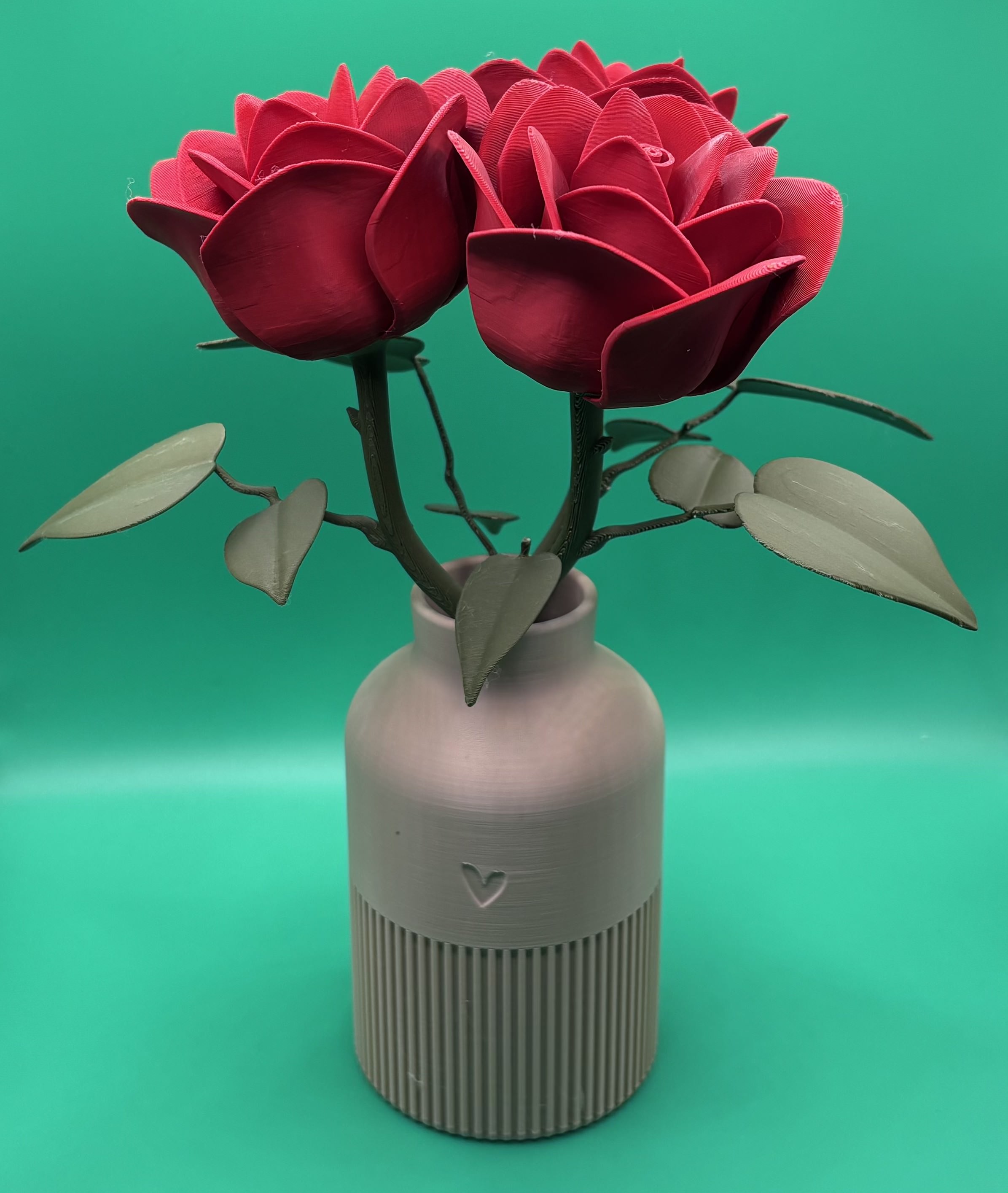 3D printed red rose bouquet arranged in a textured vase with heart detail, designed as decorative home décor.