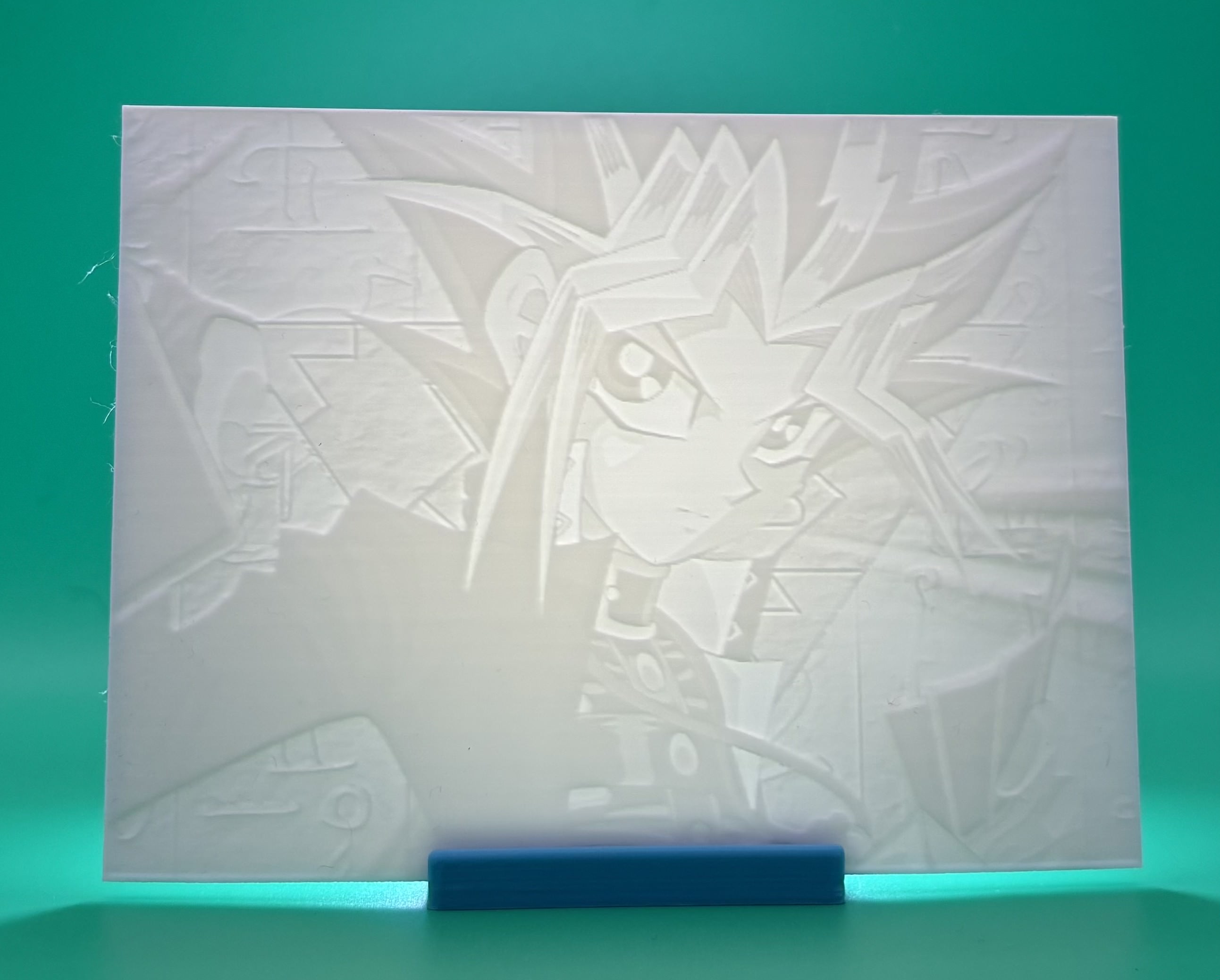 Custom 3D printed lithophane of an anime-style duelist character with spiked hair 		and intense expression, backlit fan art display
