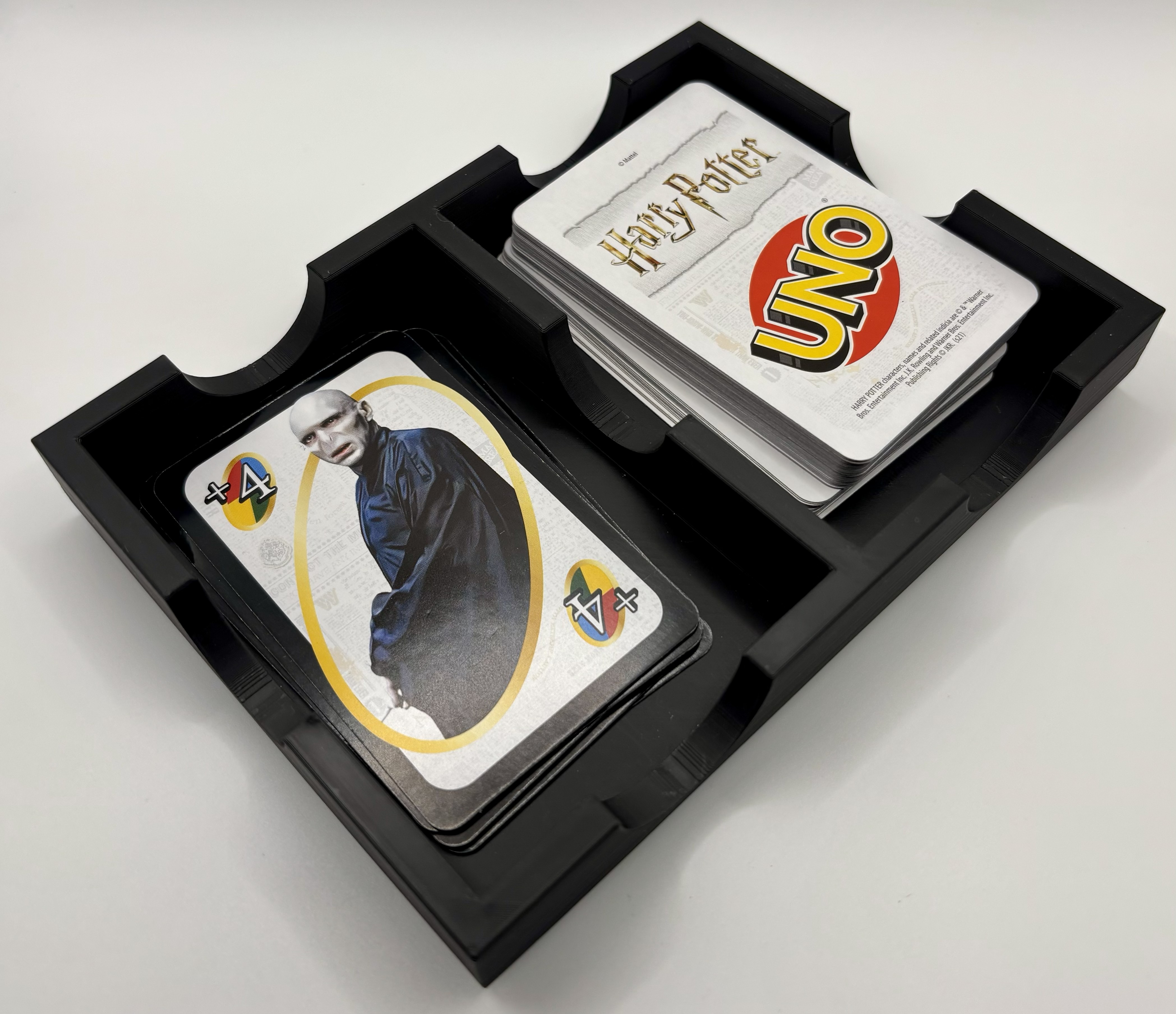 3D printed card holder in use holding draw and discard piles