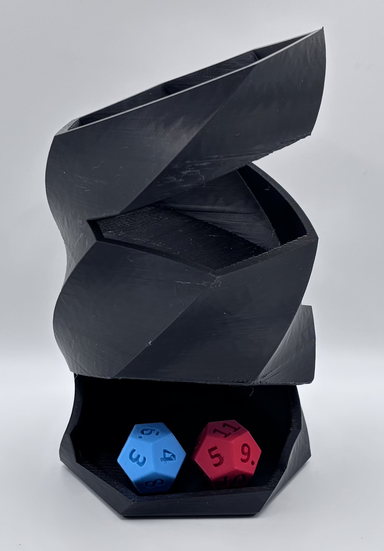 3D printed twisted dice tower with angular geometric design and integrated dice tray